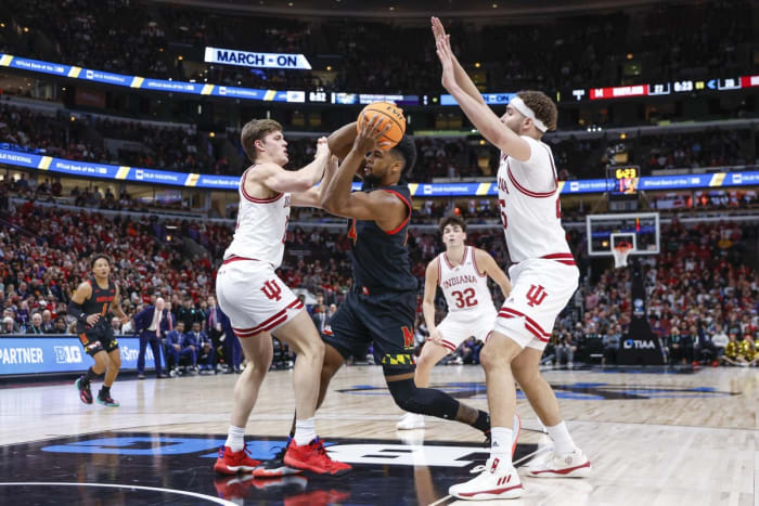 Maryland's Donta Scott (24) drives to the basket against the Indiana's Miller Kopp (12) and Race Thompson (25) during the first half at United Center.